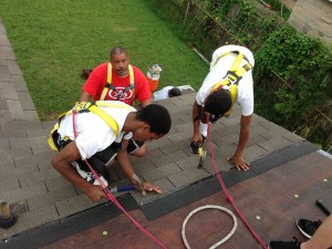 SOS Construction Manager Ellis Hull teach youth how to reroof